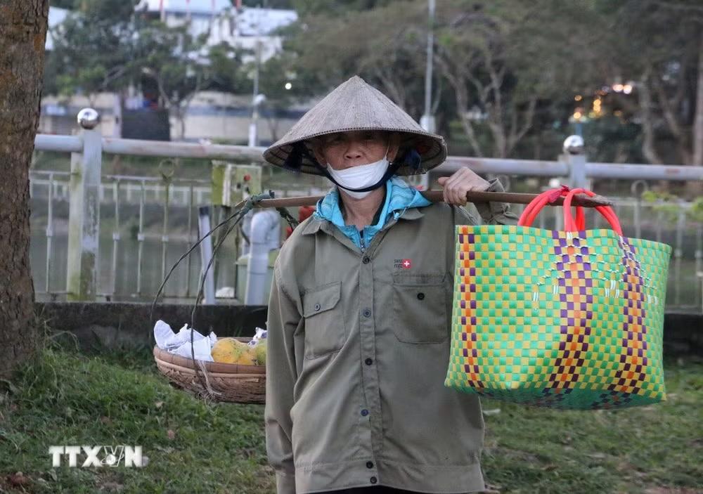 Từ hai, ba giờ sáng, người dân núi Cấm gánh hàng hóa đến chợ Mây cho kịp giờ nhóm chợ. (Ảnh: Công Mạo/TTXVN)