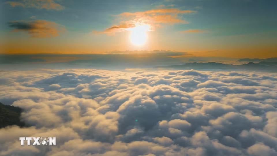 Bình minh phủ ánh vàng lên biển mây rộng lớn nhìn từ đỉnh đèo Tằng Quái. (Ảnh: Xuân Tư/TTXVN)