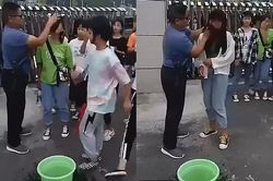 Thầy giáo đứng cổng trường lau sạch mặt nữ sinh trang điểm trước khi cho vào lớp