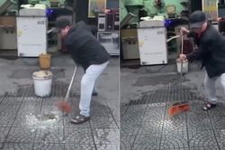 Người đàn ông hắt nước bẩn lên ô tô đỗ trước cửa hàng