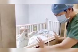 Người bố bật khóc vì không thể bế con trai nhiễm virus Corona bị cách ly