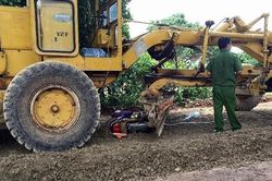 Xe ủi đất lùi cuốn 2 mẹ con vào gầm