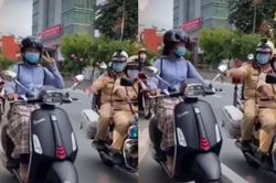 Giơ tay lên chụp ảnh khi đang chạy xe máy, cô gái giật mình khi CSGT xuất hiện yêu cầu tấp vào kiểm tra