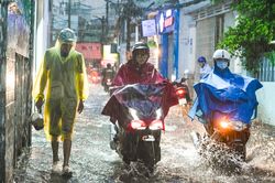 Người dân TP.HCM lội bì bõm trong cơn mưa lớn giờ tan tầm