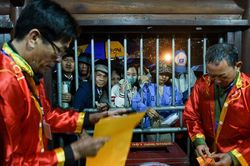 Người dân cầm sẵn tiền lẻ, ngủ gật trong lúc xếp hàng chờ lấy ấn đền Trần