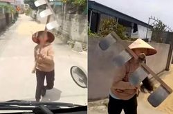 Dùng cào tấn công tài xế khi bị nhắc nhở phơi lúa trên đường
