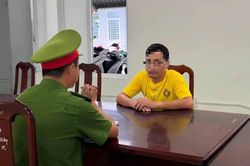 Ma men dẫn lối, người đ&agrave;n &ocirc;ng chặn xe, cầm d&eacute;p v&agrave; mũ bảo hiểm đ&aacute;nh du kh&aacute;ch