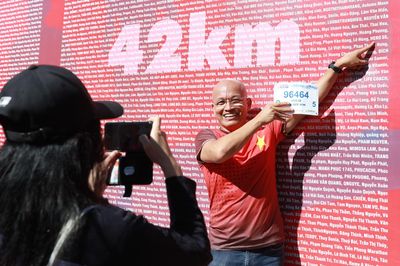 Runner hào hứng nhận BIB, thích thú 'check-in' biển tên tại Tiền Phong Marathon