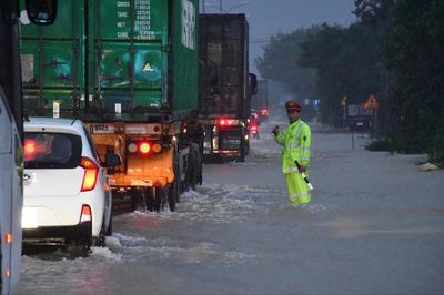 Hướng dẫn người dân lưu thông qua cầu trong mưa lớn