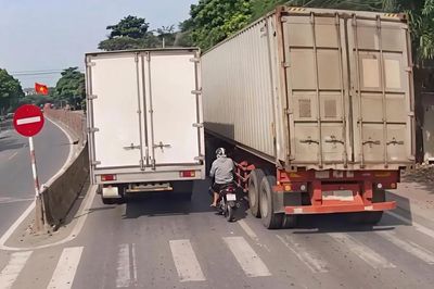 Thót tim cảnh thanh niên đi xe máy cố luồn lách giữa hai xe tải rồi lại vượt phải
