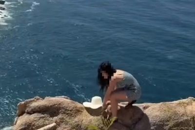 Nữ du khách liều mình đi trên vách đá cheo leo ở Nha Trang