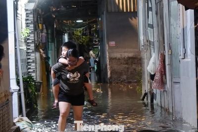 Nước tràn vào nhà, người dân TPHCM tất tả đắp bao cát 'chạy' ngập