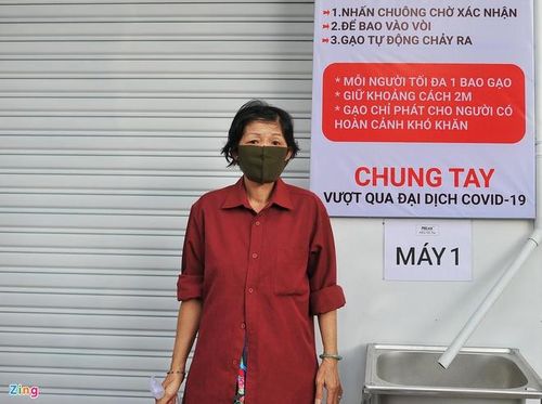 "Máy ATM gạo" ở quận Tân Phú (TP.HCM) hoạt động nhiều ngày qua đã giúp hàng trăm người nghèo có lương thực tránh đói trong mùa dịch. Là một trong số hàng trăm người đến nhận gạo từ "máy ATM gạo", bà Bùi Thị Kim Hoa (quận Phú Nhuận) cho biết khoảng 2 kg gạo được nhận mỗi ngày giúp gia đình thoát đói. 5 năm nay, bà bán vé số mưu sinh, từ khi được thông báo ngừng hoạt động bán vé số, gia đình bà lâm cảnh khó khăn. "Chẳng nói quá, nhưng nếu không có những phần gạo từ thiện này tôi không biết gia đình mình lấy gì ăn. Xin cám ơn những Mạnh Thường Quân đã làm nên 'máy ATM gạo' này", bà Hoa cho hay. Ảnh: Phạm Ngôn.