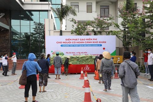 Người dân tuân thủ hướng dẫn khi nhận gạo