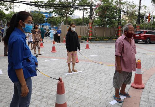 Đội ngũ đoàn thanh niên hỗ trợ hướng dẫn mọi người đứng cách nhau 2m