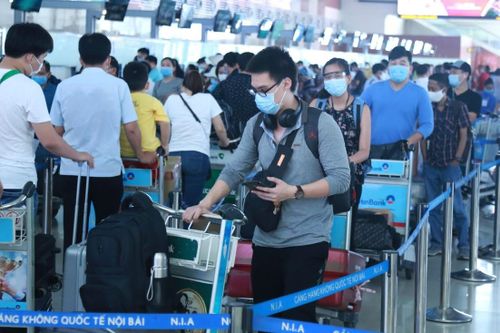Hành khách xếp hàng ngay ngắn chờ làm thủ tục tại sân bay. Ảnh: Quang Vinh.