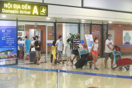 Hành khách đáp xuống Sân bay Nội Bài đều thực hiện đeo khẩu trang. Ảnh: Quang Vinh.