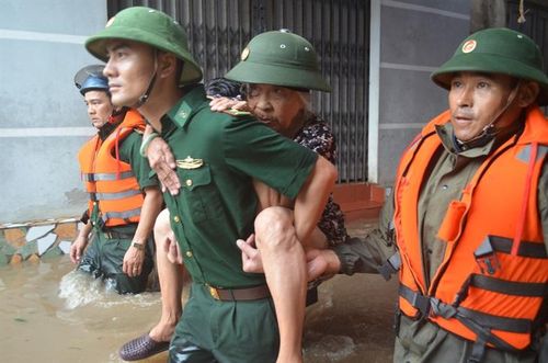 Cán bộ, chiến sĩ Đồn Biên phòng Cát Hải giúp người già tạm sơ tán khỏi vùng ngập lụt. Ảnh: Nguyễn Quang Vinh