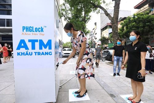 Công ty Vũ trụ Xanh (Thương hiệu khóa PHG Lock) phối hợp với Đài Tiếng nói Việt Nam - Đài Truyền hình Kỹ thuật số VTC lắp đặt cây ATM phát khẩu trang miễn phí tại 23 phố Lạc Trung, Hai Bà Trưng, Hà Nội. (Ảnh: Thành Đạt/TTXVN)