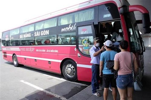 Hành khách được đo thân nhiệt trước khi lên xe rời Đà Nẵng. (Ảnh: Trần Lê Lâm/TTXVN)