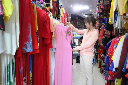 Chị Nguyễn Thị Khánh Hòa (phường Thắng Lợi, TP. Pleiku) lựa áo dài để thuê mặc dịp 8-3. Ảnh: Nhật Hào