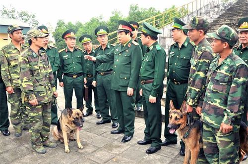 Đại tướng Phùng Quang Thanh và Đoàn công tác Bộ Quốc phòng, Bộ Tư lệnh BĐBP ân cần thăm hỏi, động viên các huấn luyện viên chó chiến đấu tại Trường Trung cấp 24 Biên phòng, năm 2016. Ảnh: Hoàng Anh