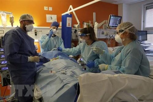 Nhân viên y tế điều trị cho bệnh nhân COVID-19 tại bệnh viện ở London, Anh. (Ảnh: AFP/ TTXVN)