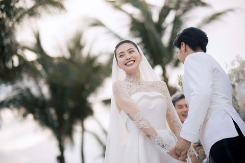 Vợ chồng Ngô Thanh Vân cười rạng rỡ khi nắm tay hạnh phúc trên sân khấu chính.