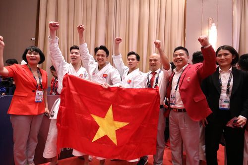 Phó Tổng Cục trưởng Tổng cục TDTT Việt Nam Lê Thị Hoàng Yến chúc mừng đội tuyển nam kata Việt Nam. ẢNH: DŨNG PHƯƠNG
