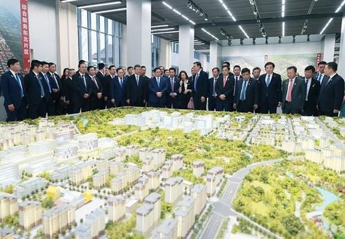 Thủ tướng Phạm Minh Chính xem sa bàn quy hoạch tổng thể Khu mới Hùng An. (Ảnh: Dương Giang/TTXVN)
