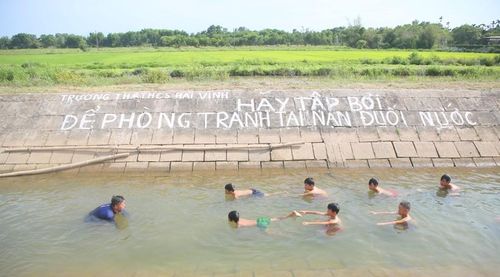 Thầy Nguyễn Viết Tước không quản ngại khó khăn để ngăn kênh thủy lợi, dạy bơi miễn phí cho học sinh vùng rốn lũ. Ảnh: Đ. Đức