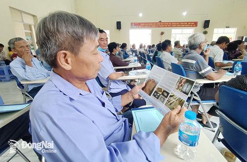 Người dân tại xã Thạnh Phú (H.Vĩnh Cửu) chăm chú đọc từng thông tin về tác hại của ma túy trong buổi tuyên truyền của Công an tỉnh