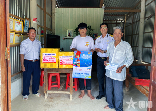  Đại diện Vùng 2 Hải quân trao quà tặng các cháu học sinh con ngư dân được Vùng nhận đỡ đầu. 