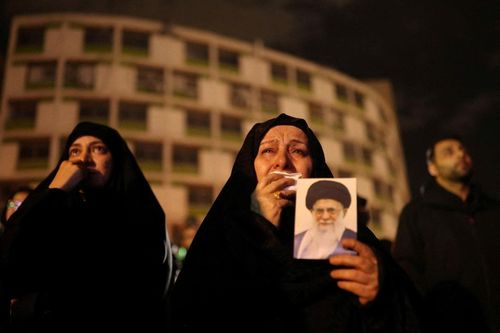 Người phụ nữ bật khóc khi cầm bức ảnh Lãnh tụ Tối cao quá cố của Iran, ông Ayatollah Ali Khamenei, tại Tehran, Iran, ngày 1/3. Ảnh: Reuters.