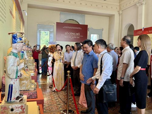 Đại biểu, khách mời và đông đảo công chúng quan tâm lắng nghe thuyết minh về các Bảo vật quốc gia.