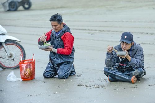Ông Thành cùng các ngư dân tranh thủ ăn vội bữa sáng ngay trên bãi biển, rồi nhanh chóng chuẩn bị ngư cụ để tiếp tục ra khơi đánh bắt sứa khi con nước còn thuận.