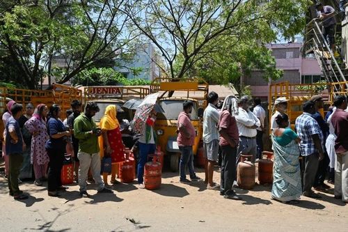  Người dân xếp hàng trước đại lý để nạp bình gas ở Chennai, Ấn Độ, ngày 11/3. Ảnh: Reuters. 