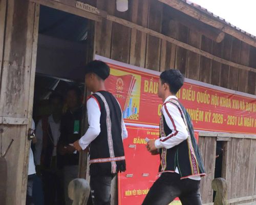Các thanh niên ở làng biệt lập O2 phấn khởi cầm lá phiếu trên tay đi bầu cử