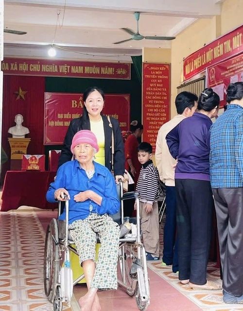 Người cao tuổi đau ốm được con cháu quan tâm đưa đến điểm bầu cử