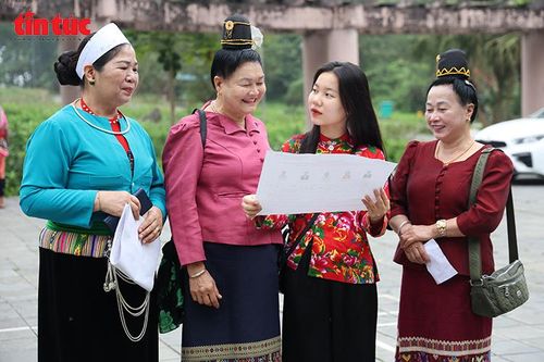 Cử tri đồng bào dân tộc trao đổi, tìm hiểu danh sách ứng cử viên trước khi vào khu vực bỏ phiếu tại Tổ bầu cử số 19.