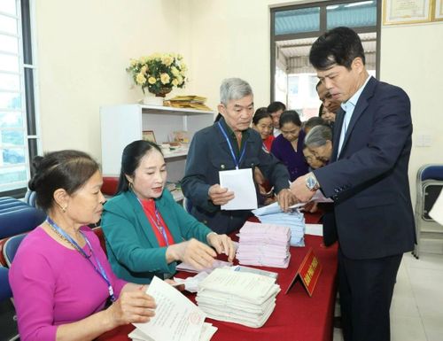 Tổ bầu cử khu vực bỏ phiếu số 65, phường Hạc Thành phát phiếu bầu cho cử tri.