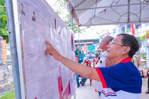 Cử tri xã Vĩnh Điều xem danh sách những người ứng cử đại biểu Quốc hội khóa XVI và đại biểu HĐND các cấp.