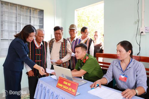 Tỉnh ủy viên, Bí thư Đảng ủy, Chủ tịch HĐND xã Phú Riềng Nguyễn Thị Xuân Hòa kiểm tra tại bàn dò danh sách cử tri ở khu vực bỏ phiếu số 2, thôn Phú Bình, xã Phú Riềng. Ảnh: Vũ Nguyện