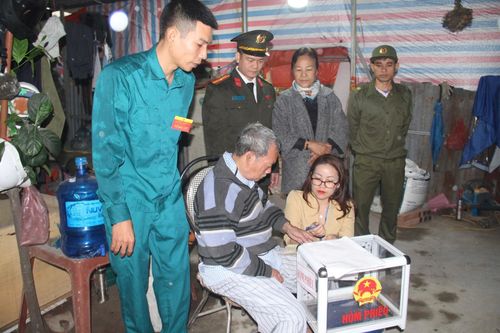 Tổ bầu cử hướng dẫn quy trình bỏ phiếu cho cử tri Nguyễn Quang Minh. Ảnh: Mai Khôi