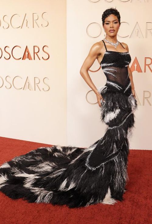 Teyana Taylor gây ấn tượng với váy dạ hội đen xuyên thấu đính sequin, kết hợp chân váy lông vũ đen - trắng cùng phần đuôi dài nổi bật. Cô hoàn thiện diện mạo bằng trang sức của Chanel và Tiffany & Co. Ảnh: Harpers Bazaar