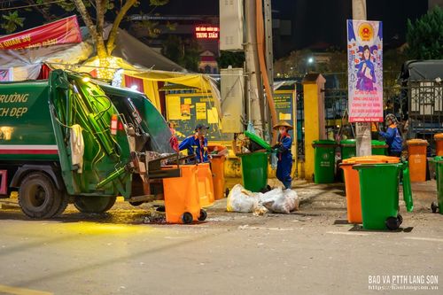 Rác từ các thùng rác lưu động đầy ắp được công nhân thu gom, đưa lên xe chuyên dụng để vận chuyển đi xử lý