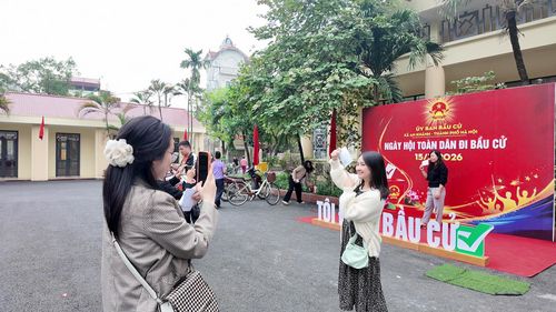 Các cử tri trẻ đua nhau tạo dáng tại điểm check-in sau khi hoàn thành nghĩa vụ công dân. Ảnh: Hoàng Phương