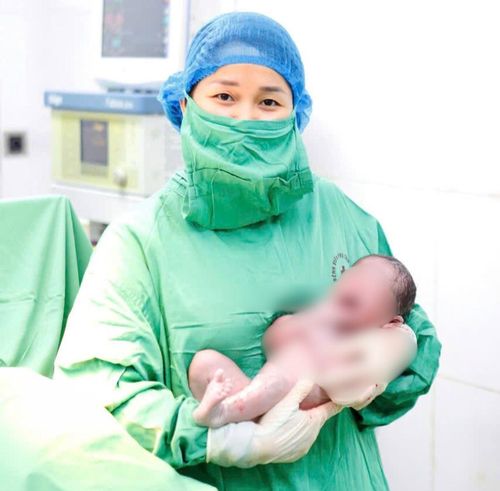 ThS.BS Nguyễn Thị Bích Ngọc bế trên tay em bé vừa chào đời tại Bệnh viện Phụ sản Hà Nội