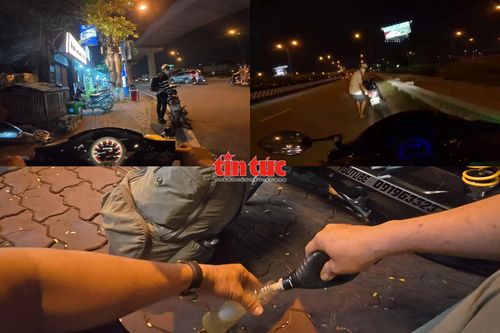 Ông Long hỗ trợ xăng cho người đi đường phải dắt xe do hết xăng vào ban đêm.