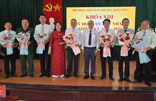 Chủ tịch HĐND phường Hoàng Phước Nhật (thứ 4 từ phải sang) tặng hoa cho Chủ tịch, các Phó Chủ tịch và ủy viên UBND phường 